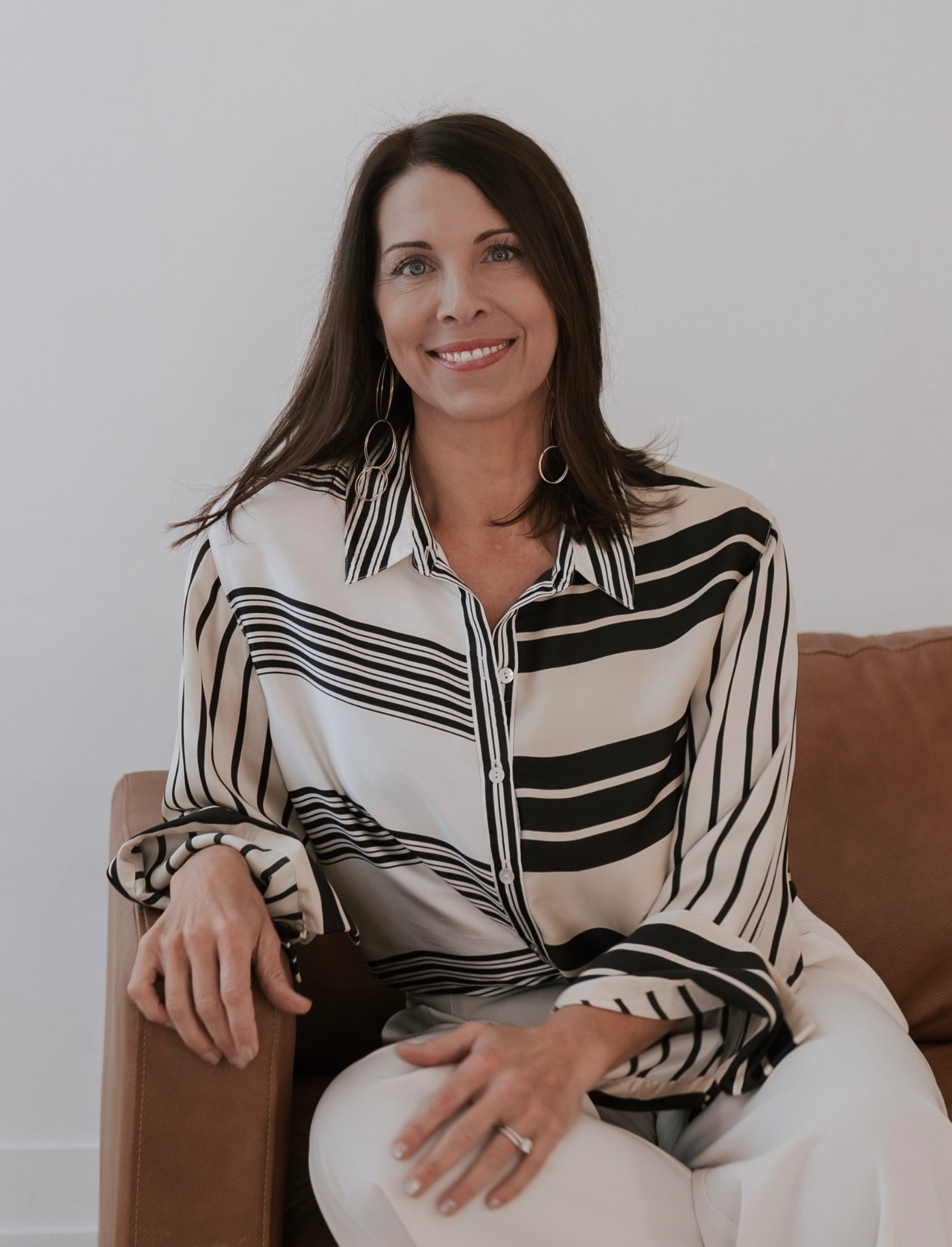 Dustina Hall, senior living advisor, seated and smiling